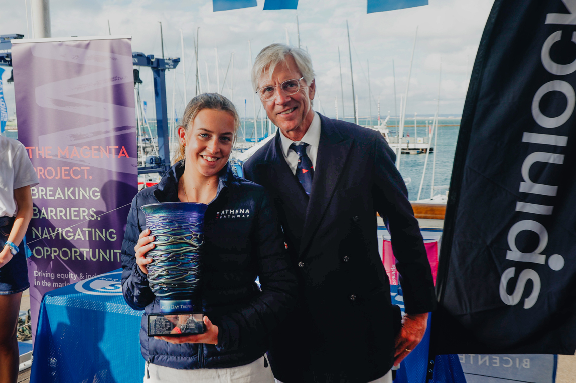 Athena Pathway's Katy Jenkins accepts the Womens Day Trophy on behalf of Hannah Mills OBE